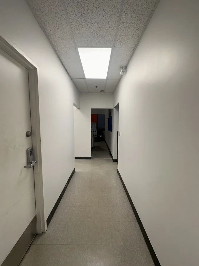 Commercial hallway at a national retail chain with fresh neutral paint by OV Property Solutions