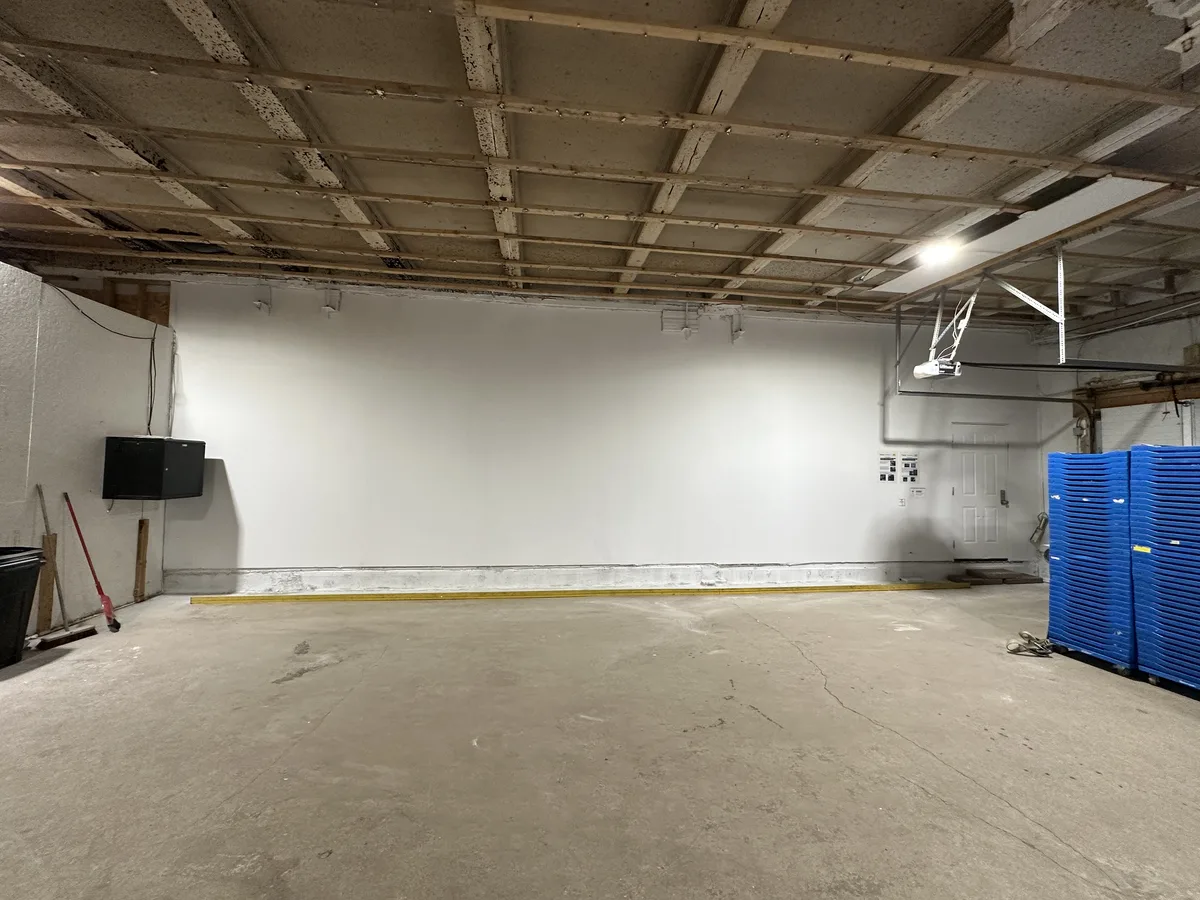 Warehouse wall rebuilt with new drywall, taped, mudded, primed and painted by OV Property Solutions