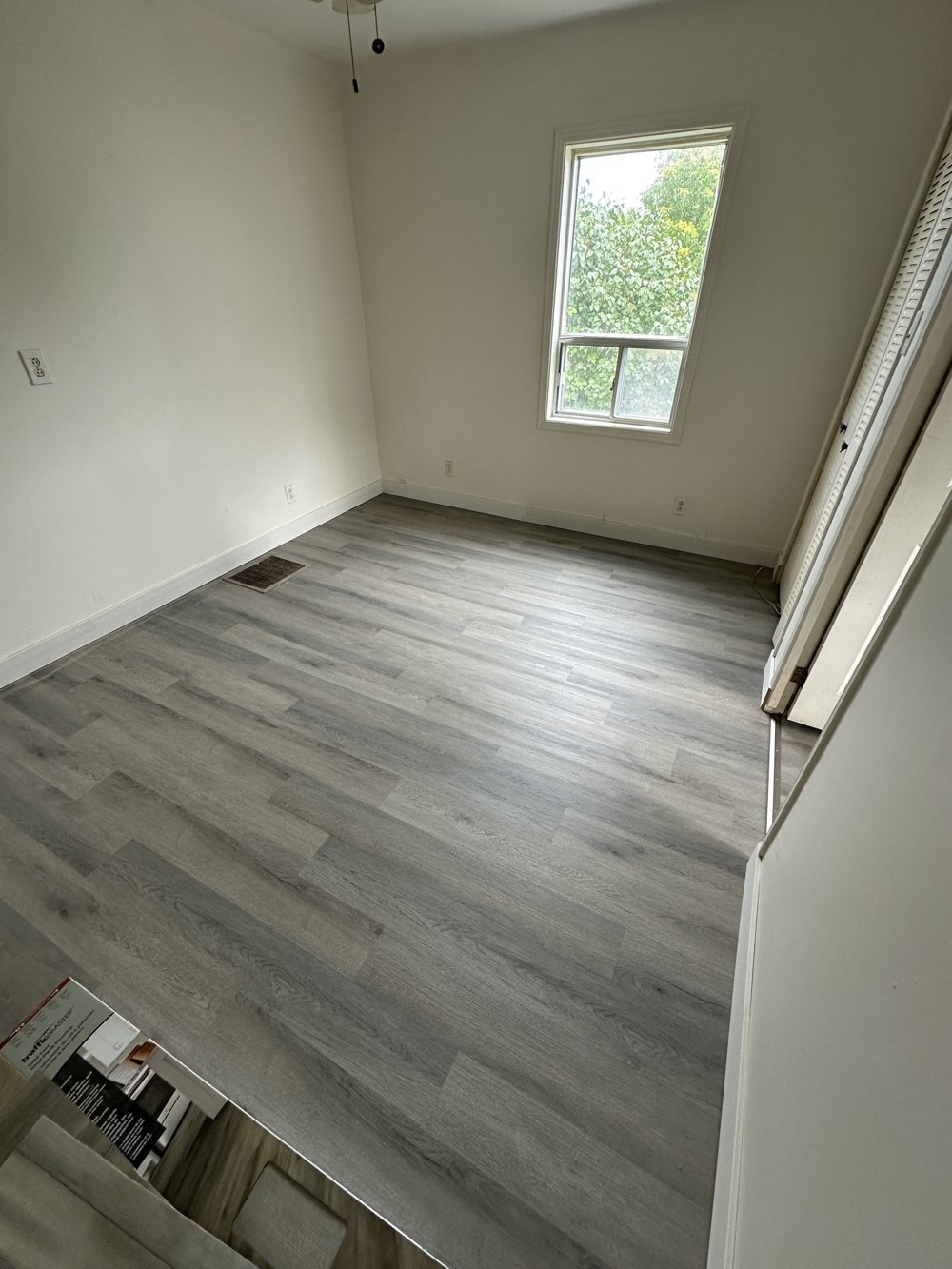 Room finished in grey vinyl plank flooring
