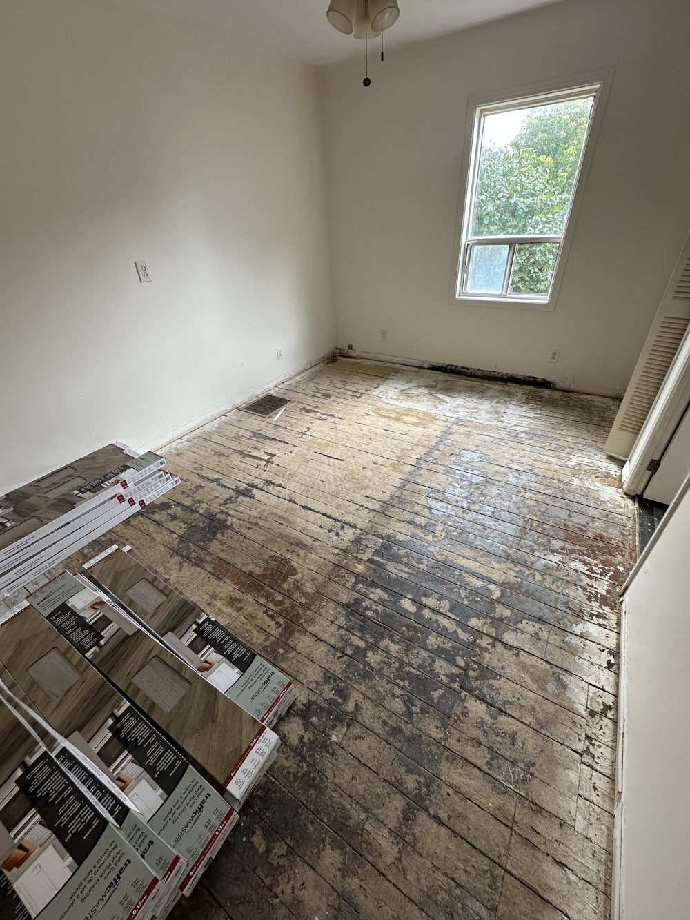 Room with a damaged plank subfloor before flooring