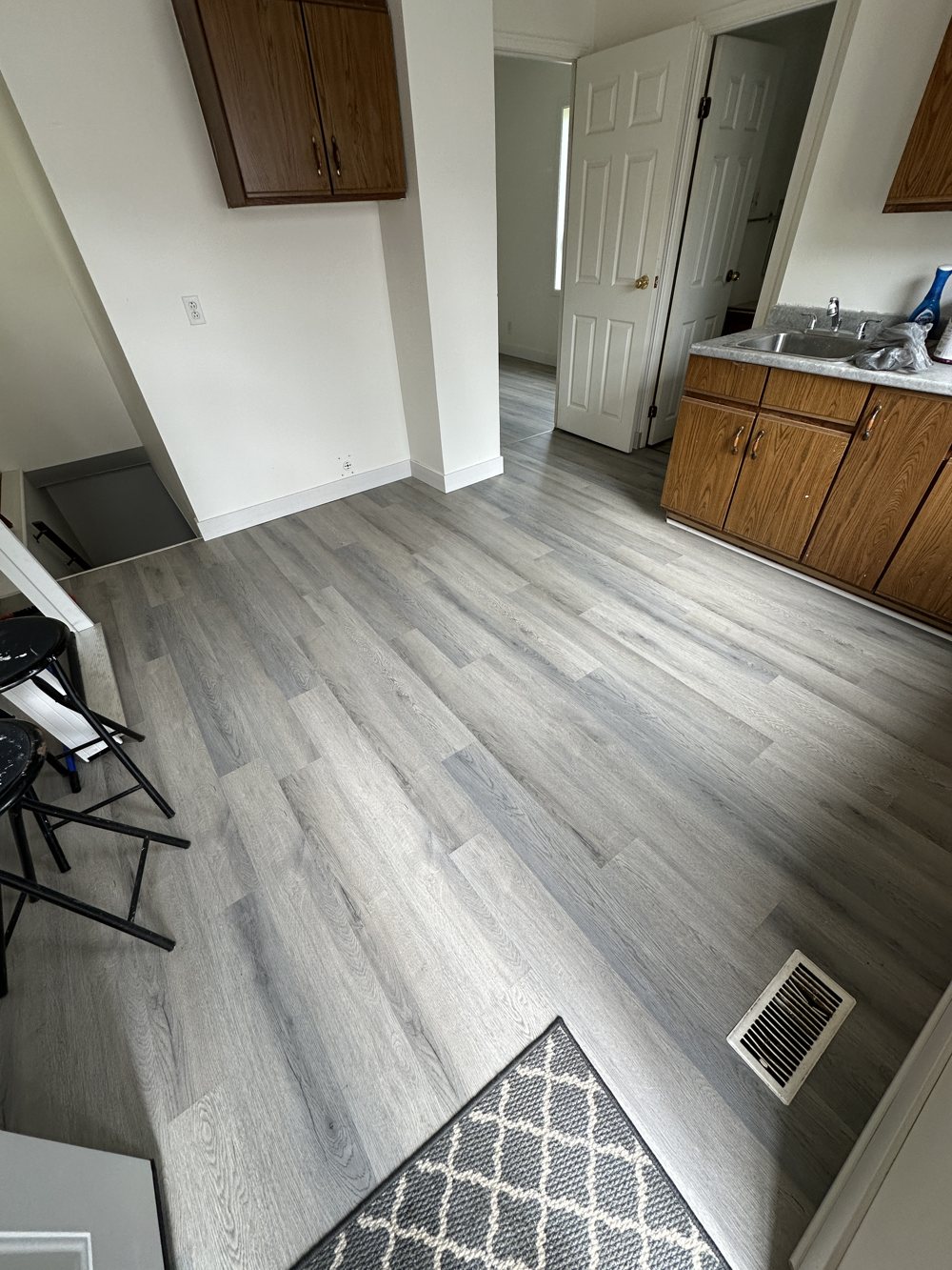 Kitchen finished in grey vinyl plank flooring