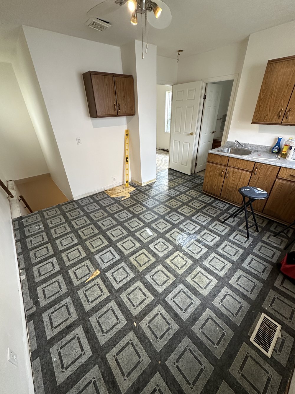 Kitchen with dated patterned tile before replacement