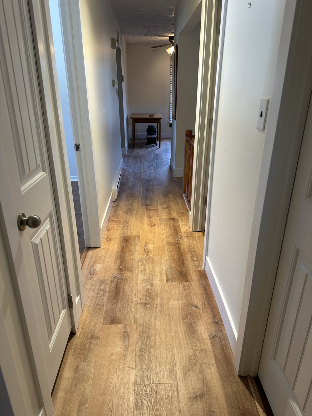 Hallway finished in light natural vinyl plank flooring