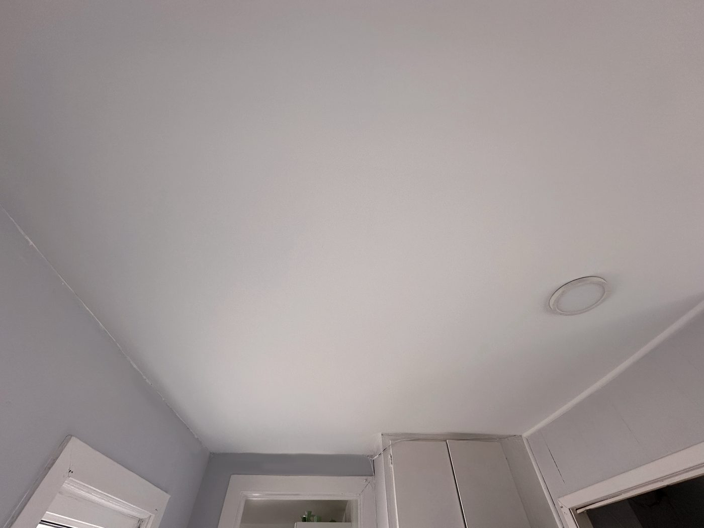 Ceiling repaired after water leak with new drywall and Benjamin Moore ceiling paint