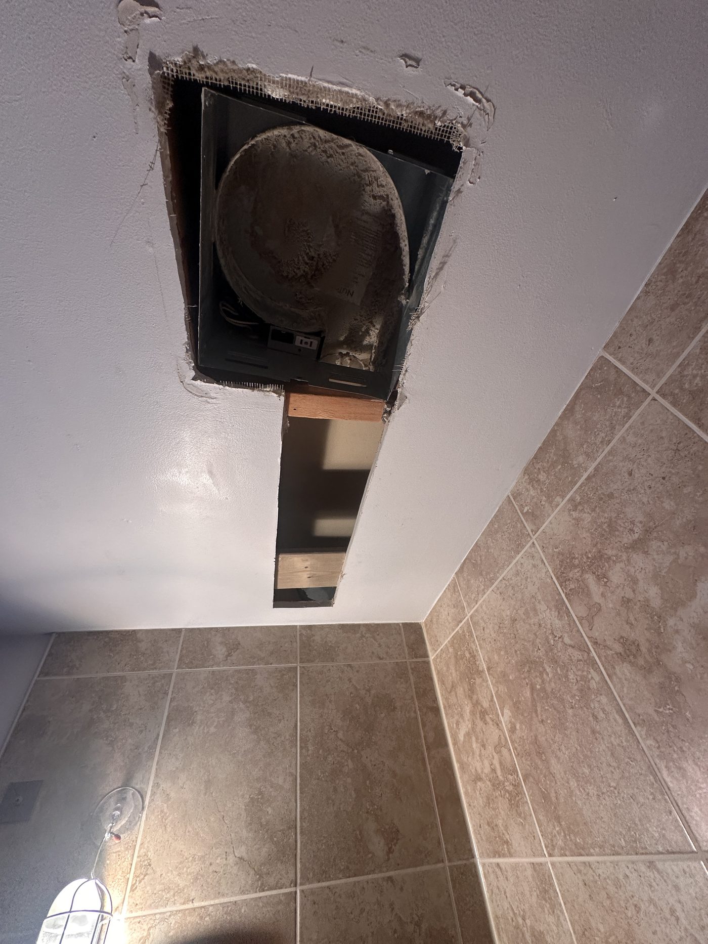 Old bathroom exhaust fan before replacement
