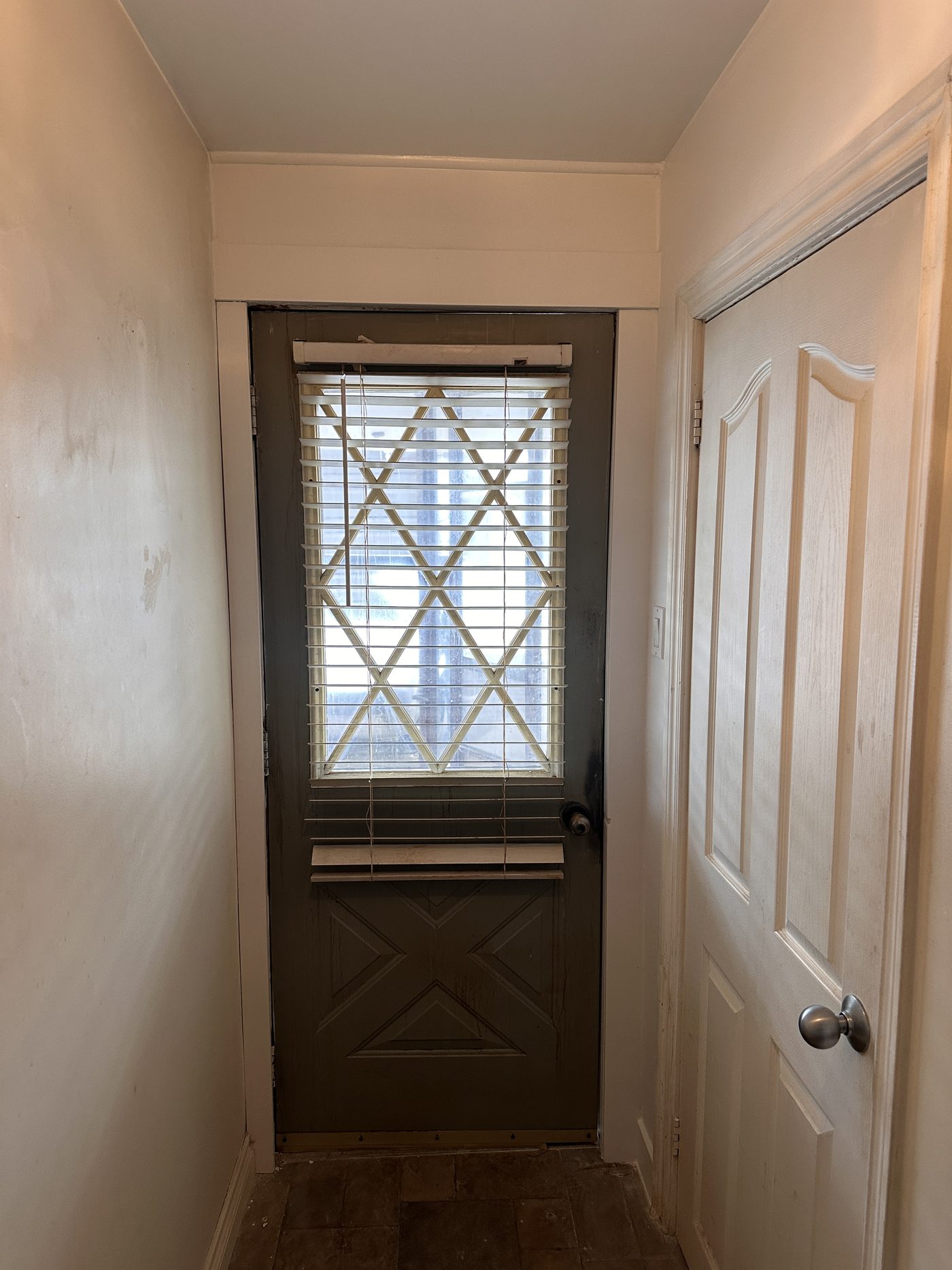 Water damage around entry door repaired: new drywall, trim and paint