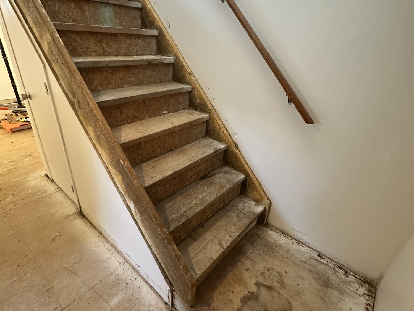 Stairs and floor before - worn treads and bare subfloor